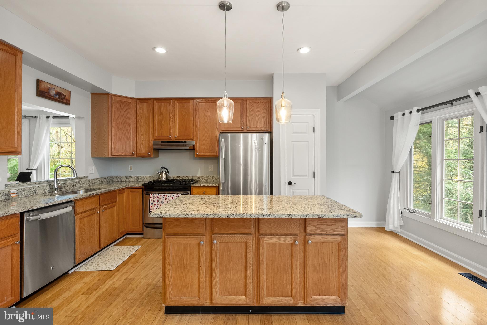 3601 Ransom Place Alexandria, VA 22306 - Photo 20 of 60 a kitchen with kitchen island granite countertop wooden cabinets a sink and a stove