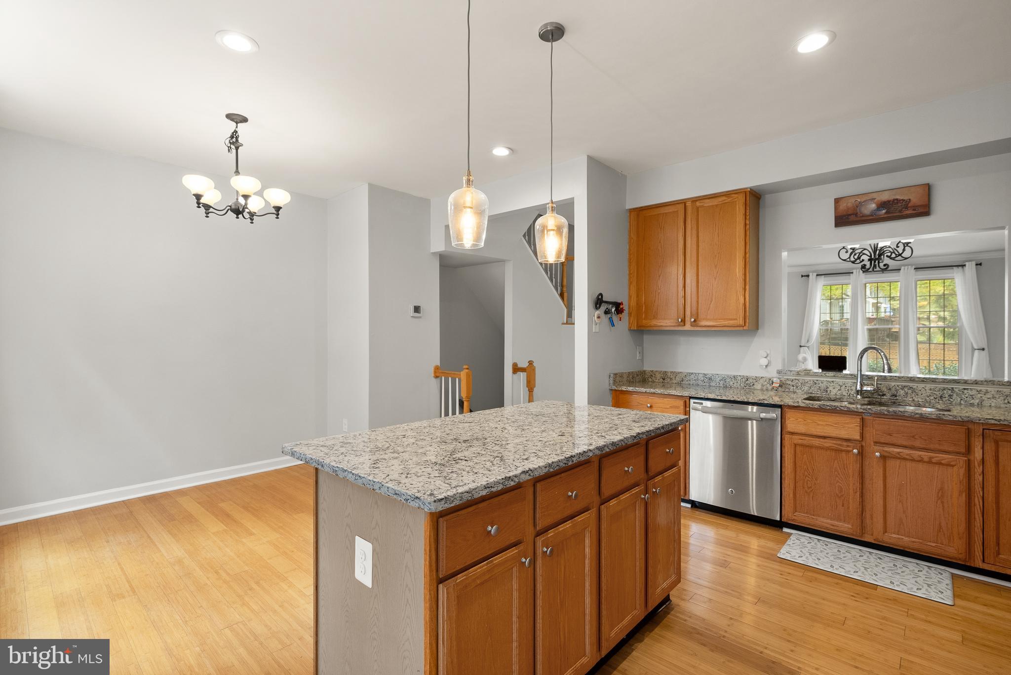 3601 Ransom Place Alexandria, VA 22306 - Photo 24 of 60 a kitchen with granite countertop cabinets a sink dishwasher and a stove with wooden floor