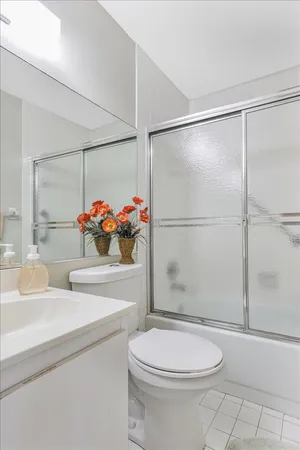 a bathroom with a sink mirror vanity and toilet