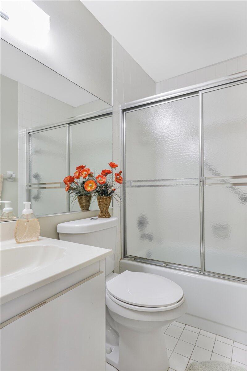 5178 Privet Place, Unit D Delray Beach, FL 33484 - Photo 13 of 41 a bathroom with a sink mirror vanity and toilet