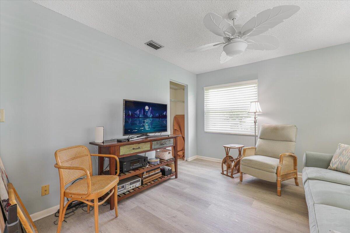 5178 Privet Place, Unit D Delray Beach, FL 33484 - Photo 15 of 41 a living room with furniture and a flat screen tv