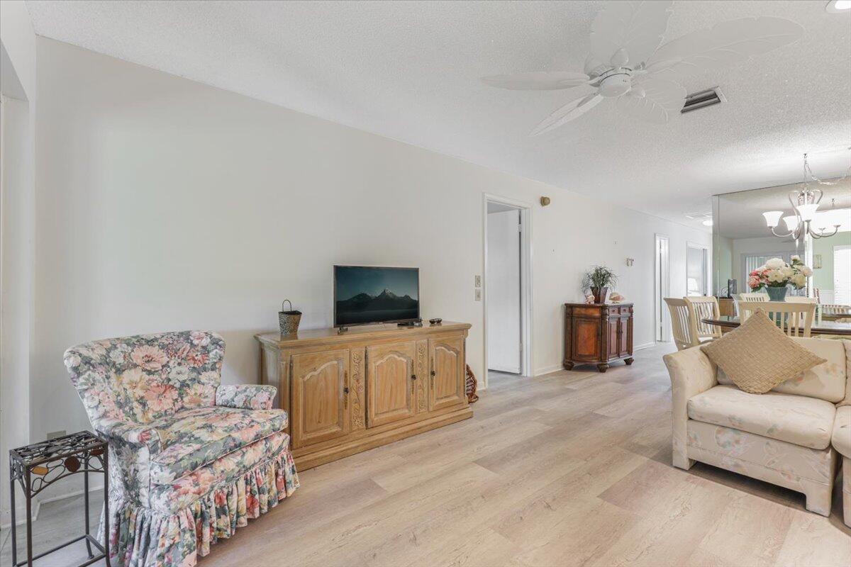 5178 Privet Place, Unit D Delray Beach, FL 33484 - Photo 20 of 41 a living room with furniture and a flat screen tv