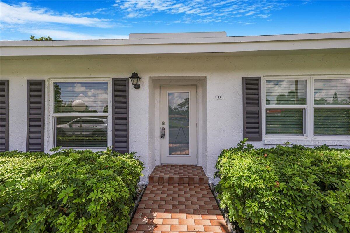 5178 Privet Place, Unit D Delray Beach, FL 33484 - Photo 2 of 41 front view of a house with a large window