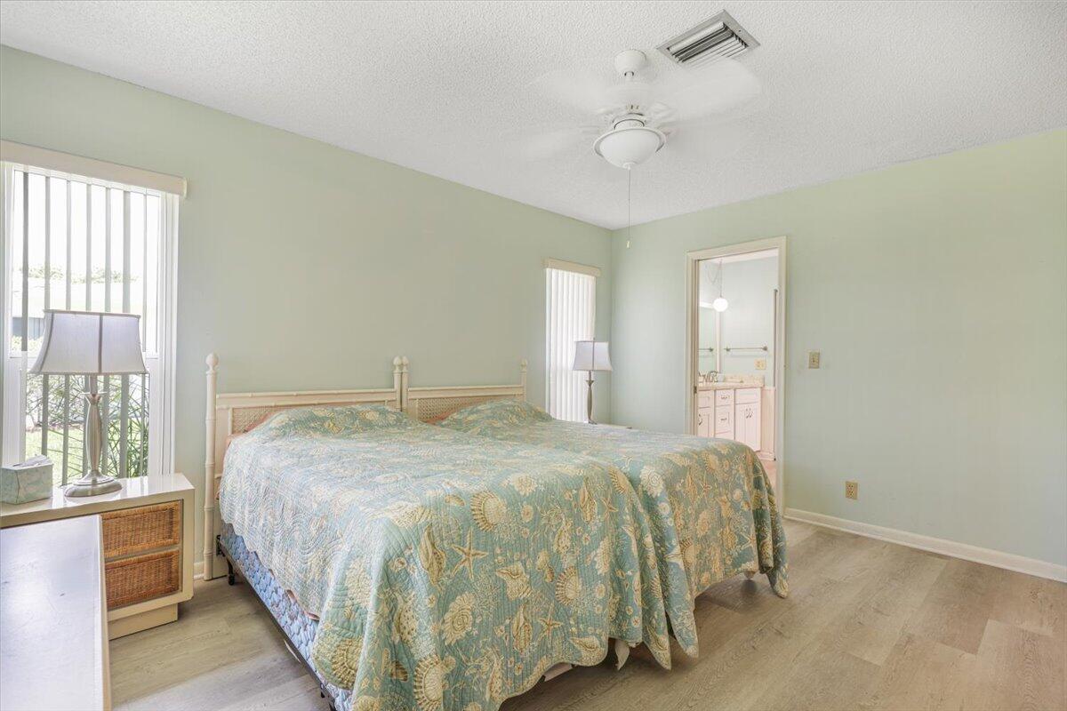5178 Privet Place, Unit D Delray Beach, FL 33484 - Photo 23 of 41 a bedroom with a bed and a window