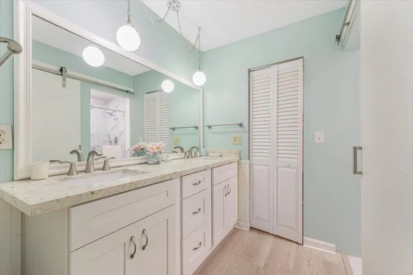 a bathroom with a granite countertop sink mirror and double