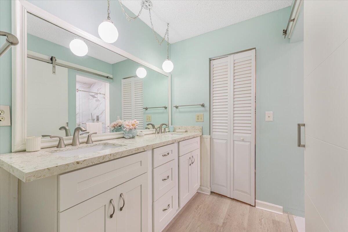 5178 Privet Place, Unit D Delray Beach, FL 33484 - Photo 24 of 41 a bathroom with a granite countertop sink mirror and double