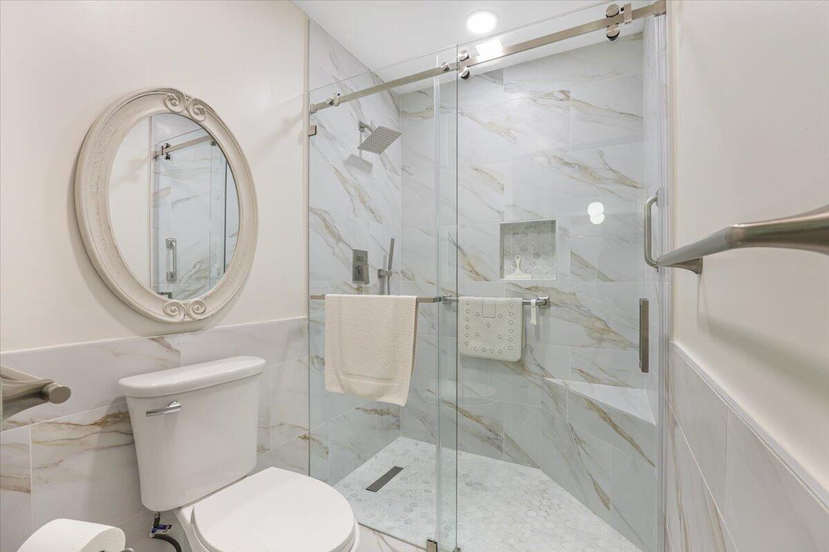 5178 Privet Place, Unit D Delray Beach, FL 33484 - Photo 25 of 41 a white toilet sitting next to a bathroom sink