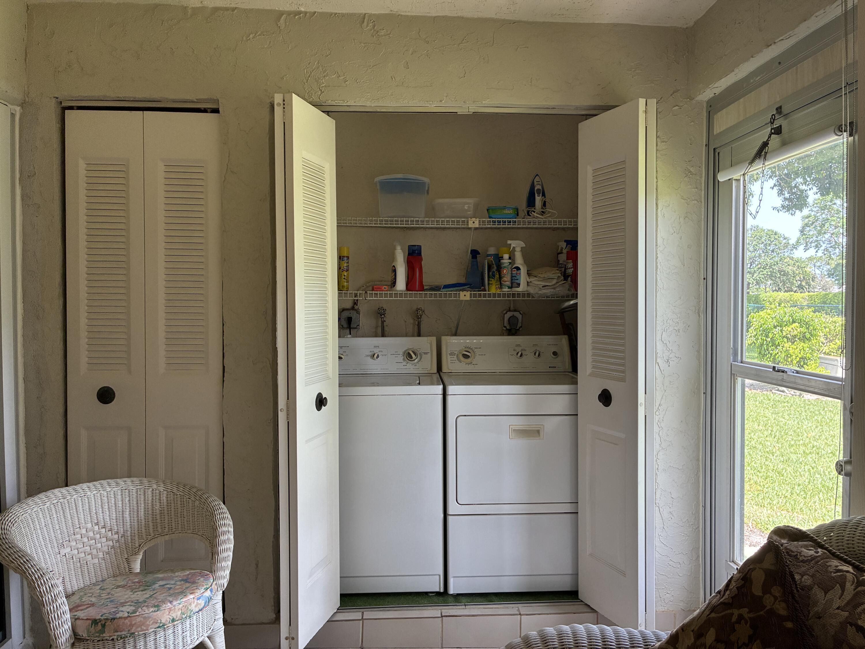5178 Privet Place, Unit D Delray Beach, FL 33484 - Photo 28 of 41 a kitchen with a refrigerator and white cabinets