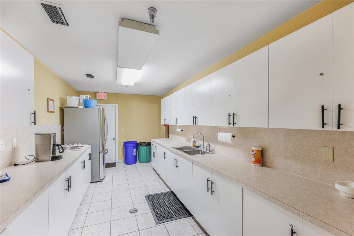 5178 Privet Place, Unit D Delray Beach, FL 33484 - Photo 33 of 41 a kitchen with a sink and cabinets