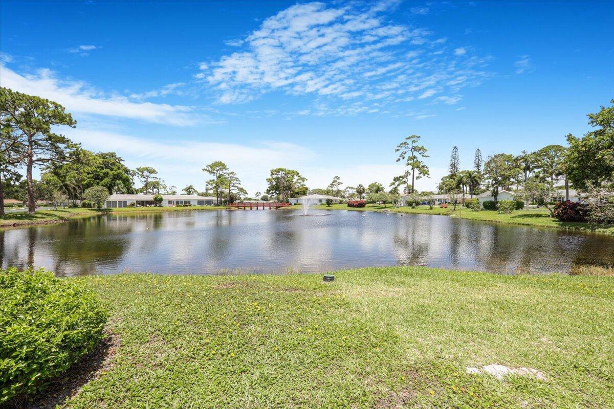 5178 Privet Place, Unit D Delray Beach, FL 33484 - Photo 38 of 41 a view of a lake with houses in the back