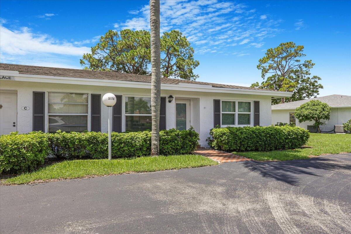 5178 Privet Place, Unit D Delray Beach, FL 33484 - Photo 4 of 41 a view of a brick house with a yard