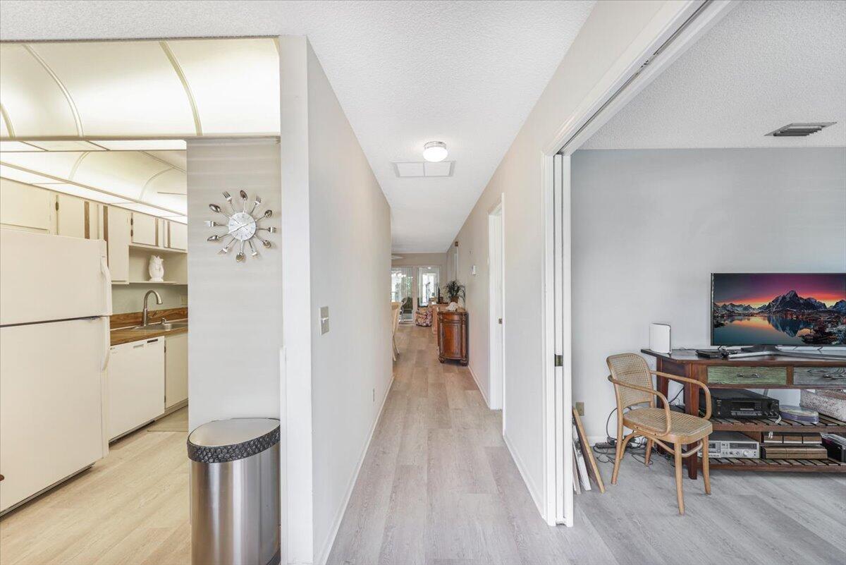 5178 Privet Place, Unit D Delray Beach, FL 33484 - Photo 5 of 41 a view of a hallway with furniture and a refrigerator