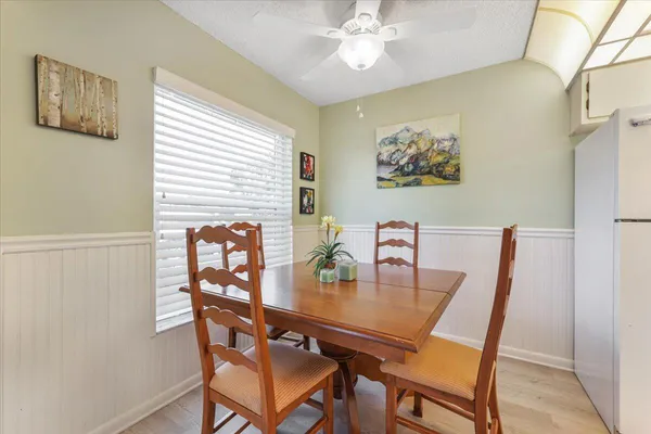 a view of a dining room with furniture and chandelier