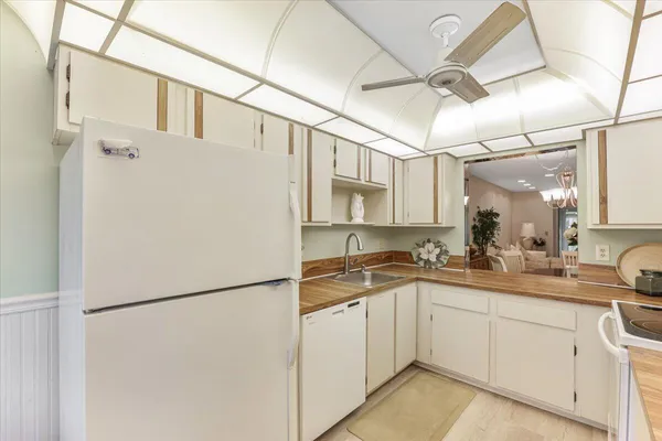 a kitchen with a sink appliances and cabinets