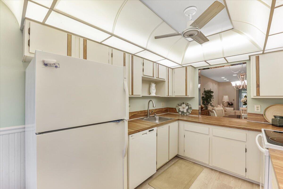 5178 Privet Place, Unit D Delray Beach, FL 33484 - Photo 8 of 41 a kitchen with a sink appliances and cabinets