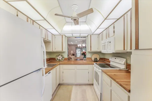 a kitchen with a sink window and cabinets
