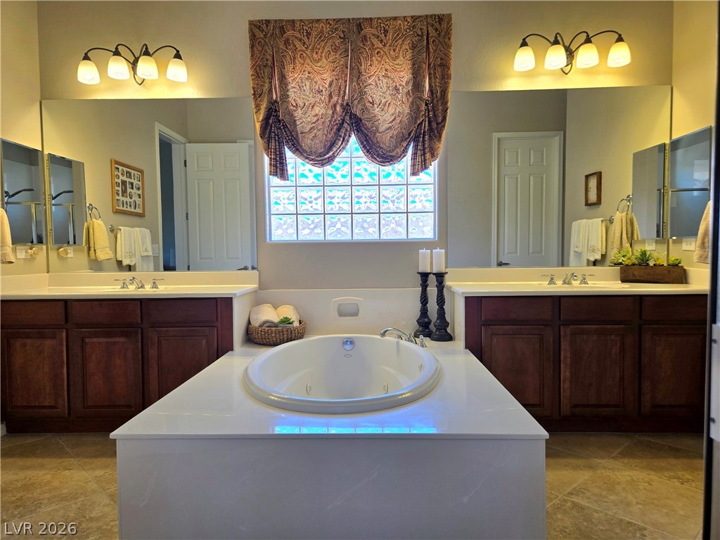 2567 Dirleton Place Henderson, NV 89044 - Photo 35 of 67 Indulge in relaxation within this primary bathroom, featuring a deep soaking tub and dual vanities.