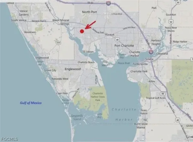 a white vase with flowers sitting on a floor