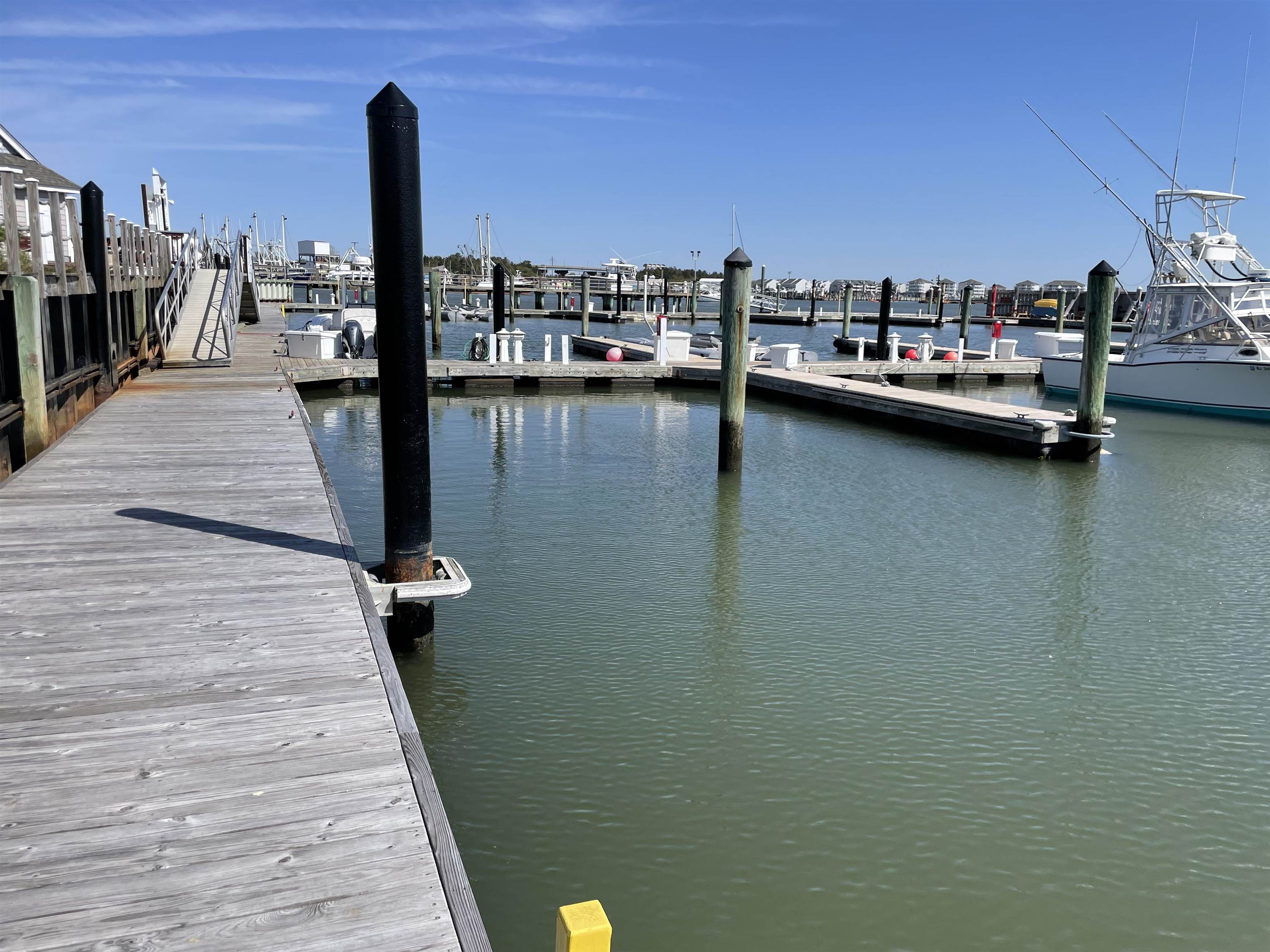 38 Harbor Lane Cape May, NJ 08204 - Photo 18 of 34 a view of a lake with boats and trees in the background