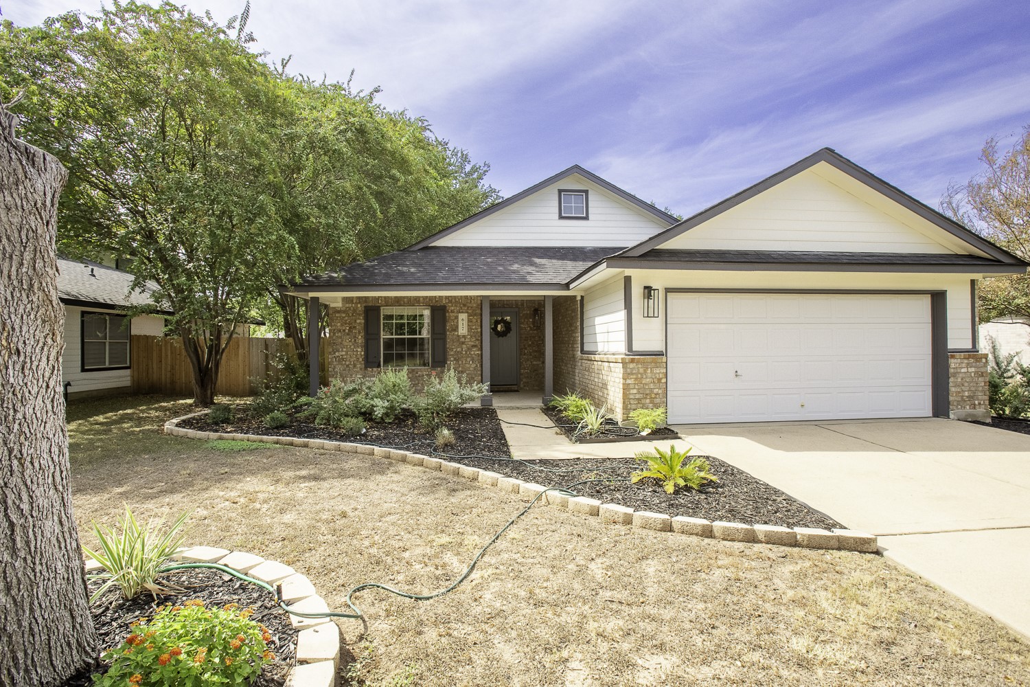 617 Barbara Way Bastrop, TX 78602 - Photo 4 of 39 Traditional home with a porch, brick siding, concrete driveway, and a garage