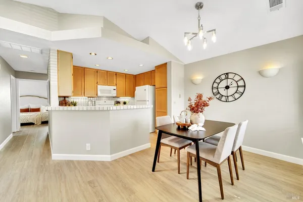 a living room with kitchen island furniture and a kitchen view