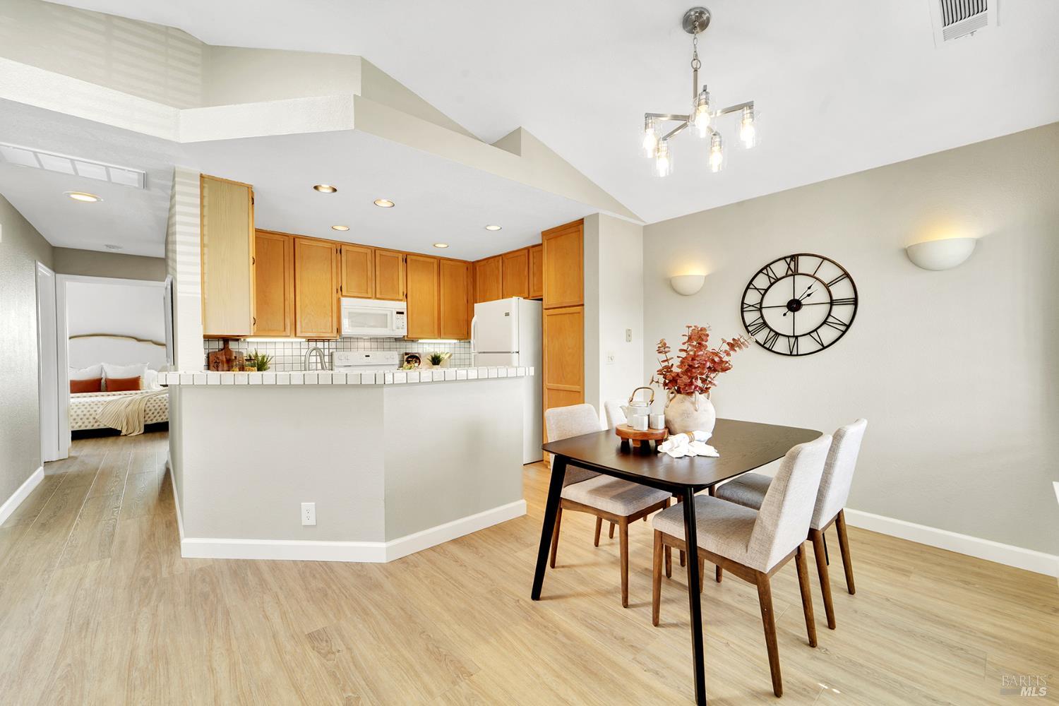 511 Timbercove Street, Unit 8 Vallejo, CA 94591 - Photo 15 of 34 a view of a dining room with furniture a chandelier and wooden floor