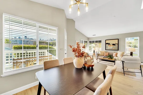 a kitchen with stainless steel appliances kitchen island granite countertop a stove and white cabinets