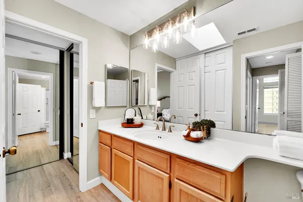 a bathroom with a double vanity sink and a mirror