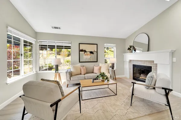 a view of a dining room with furniture a chandelier and wooden floor