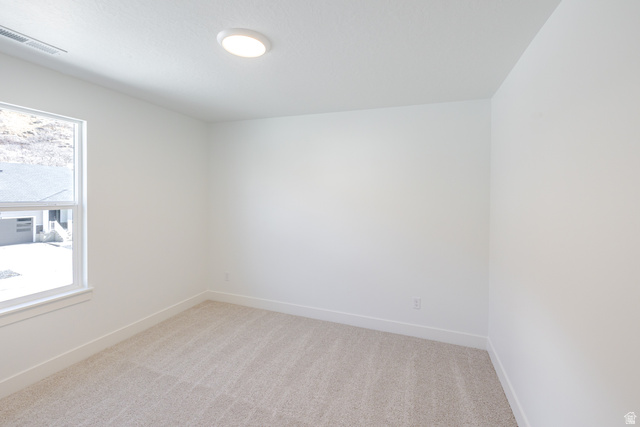 4720 Heartwood Road, Unit 438 Mapleton, UT 84664 - Photo 15 of 19 Spare room featuring light carpet and baseboards