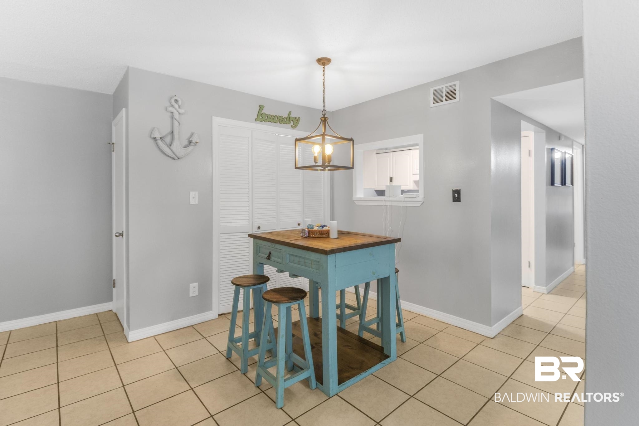 110 5th Street, Unit A 103 Daphne, AL 36526 - Photo 11 of 28 Dining space featuring light tile patterned floors and an inviting chandelier