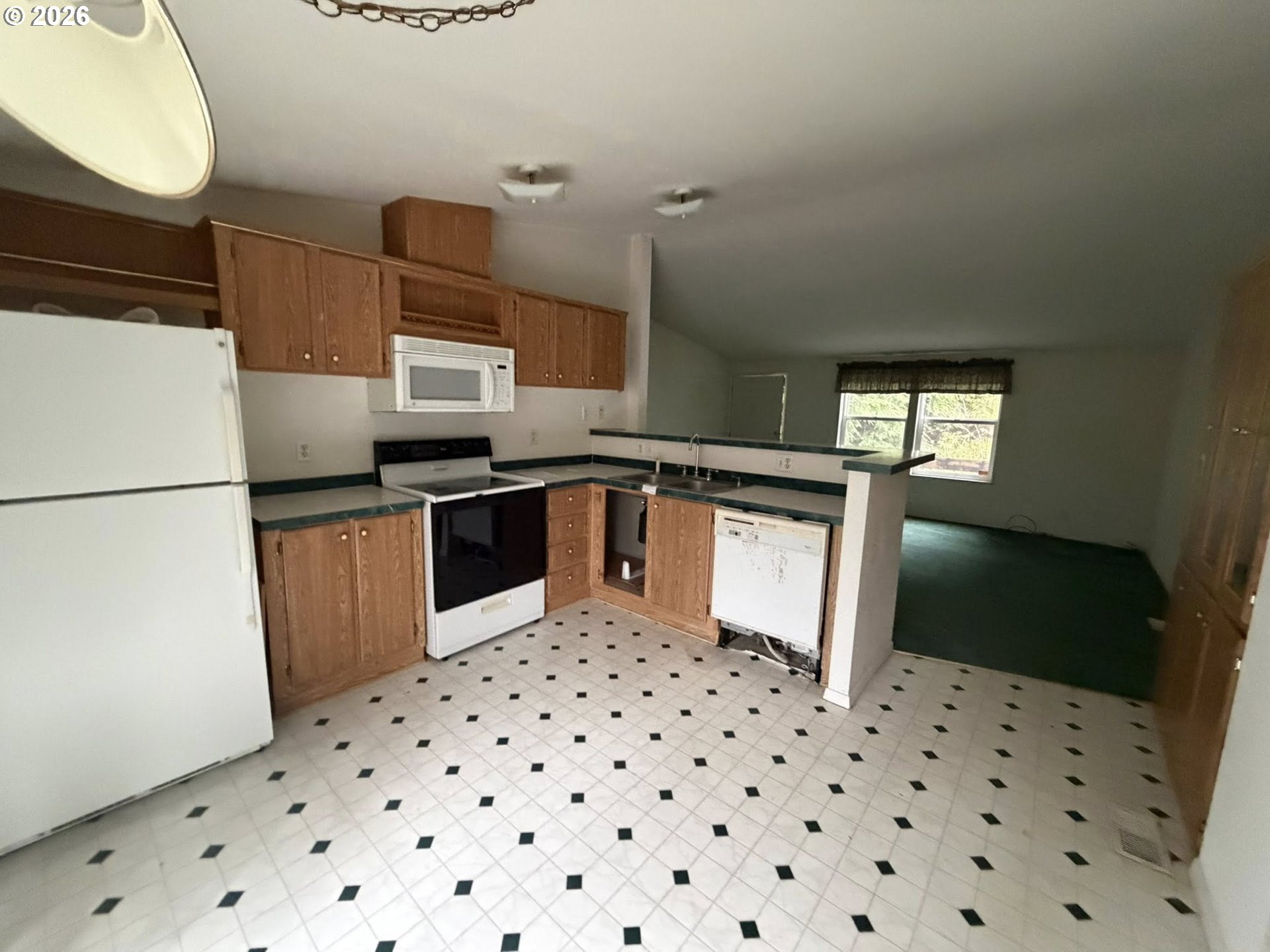 61528 Edwards Mill Road Coos Bay, OR 97420 - Photo 13 of 20 a kitchen with granite countertop a refrigerator and a sink