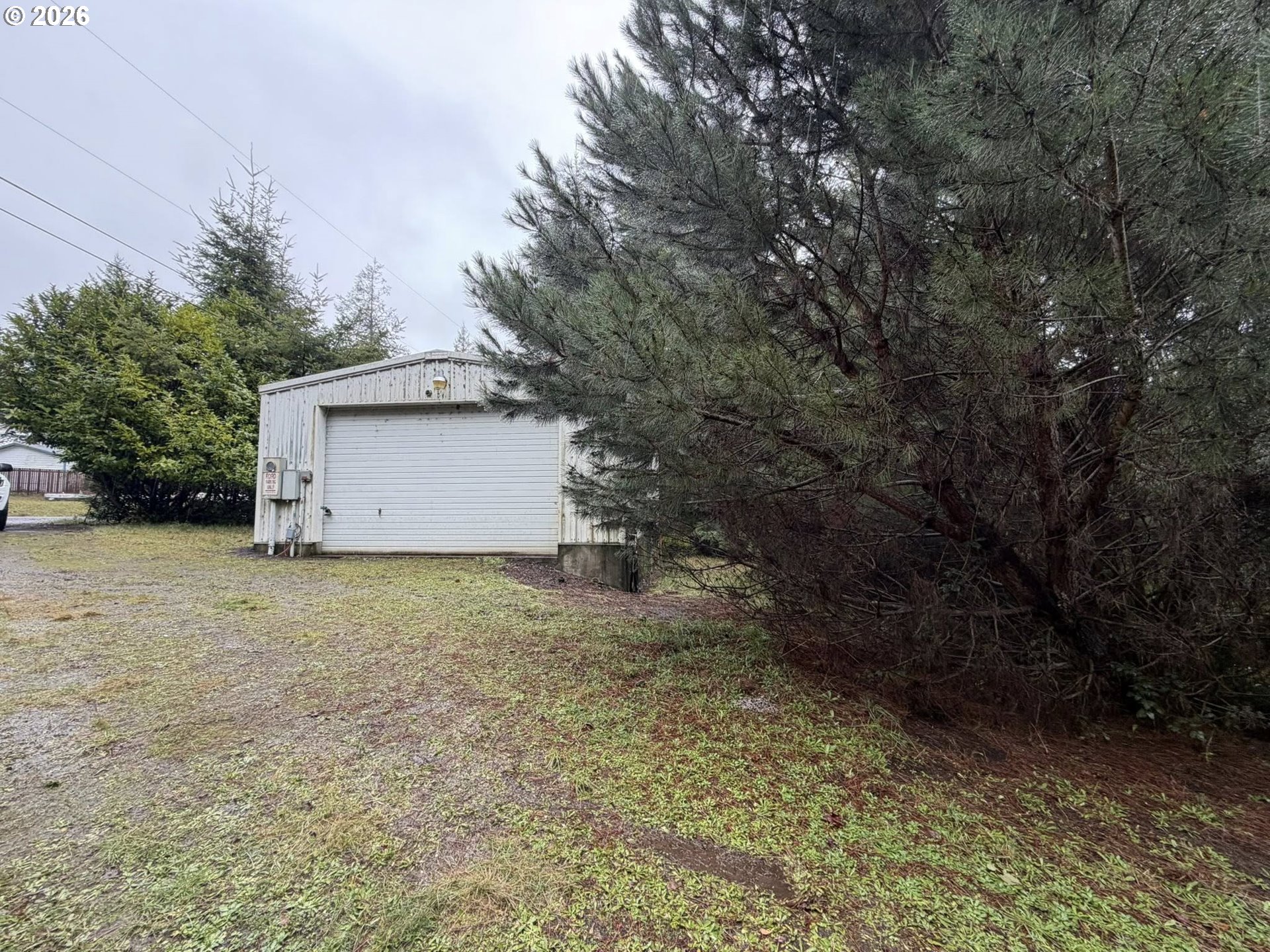 61528 Edwards Mill Road Coos Bay, OR 97420 - Photo 20 of 20 a backyard of a house with a yard and garage