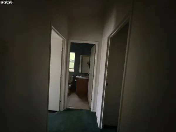 a view of a bathroom from a hallway