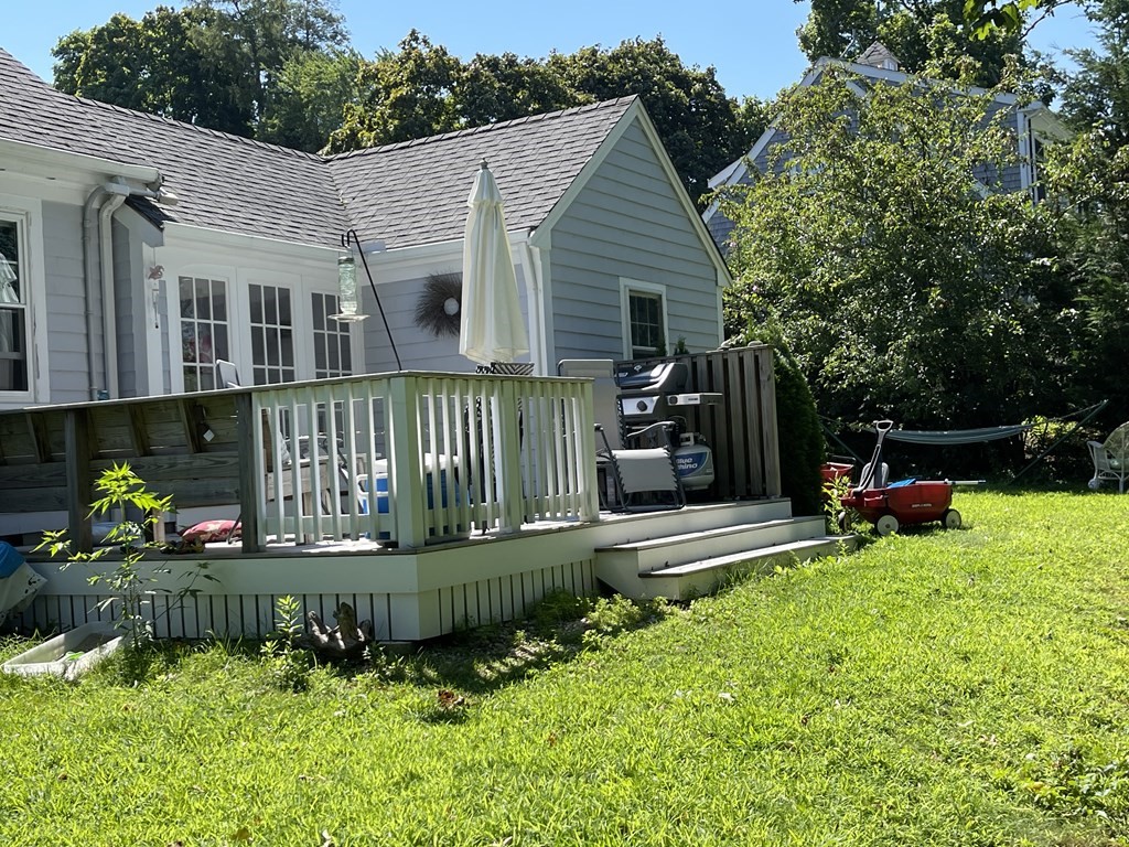4 Riverside Drive Kingston, MA 02364 - Photo 5 of 9 a front view of a house with a yard table and chairs
