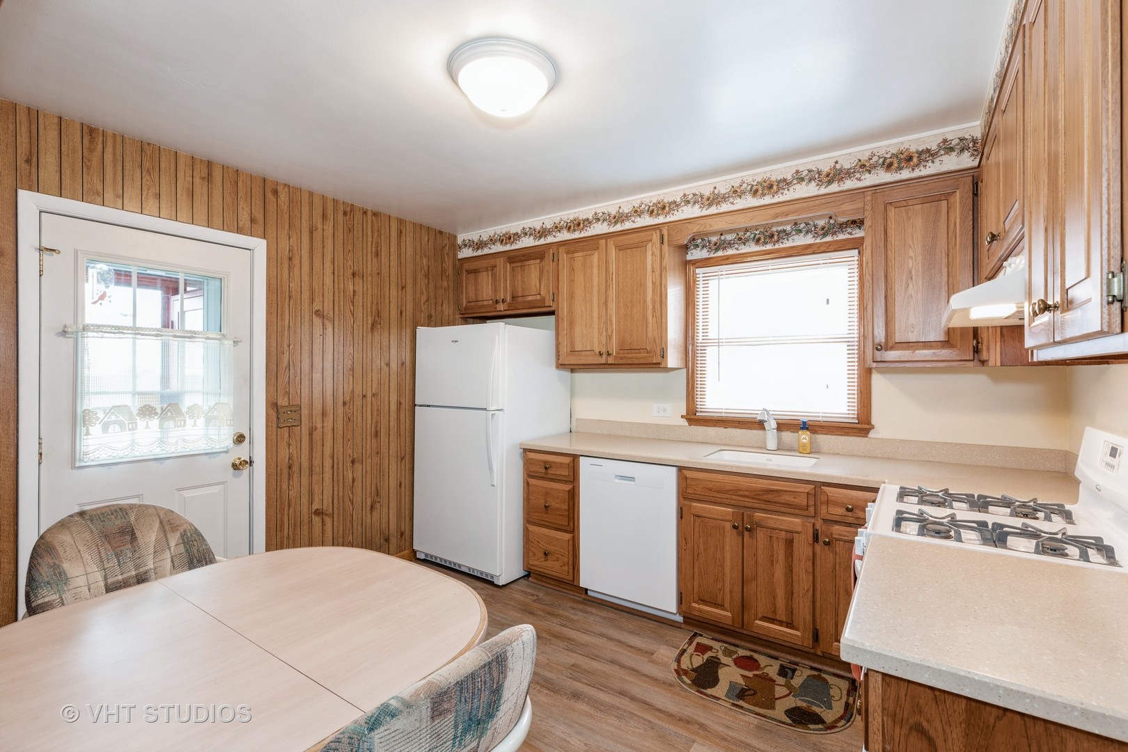 1132 Hickory Road Homewood, IL 60430 - Photo 5 of 20 a kitchen with a refrigerator a stove a sink and a window