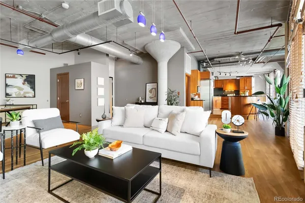 a living room with furniture and a chandelier