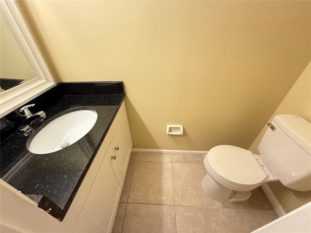 209 South Moss Road, Unit 209 Winter Springs, FL 32708 - Photo 11 of 14 a bathroom with a toilet mirror vanity and a sink