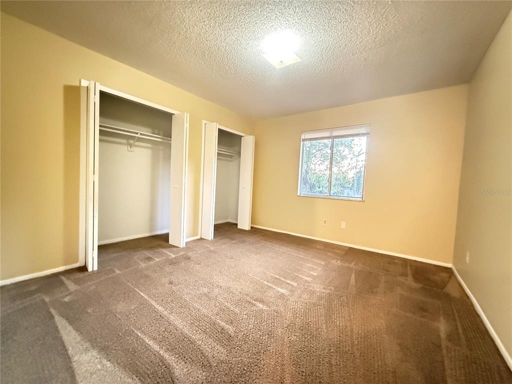 209 South Moss Road, Unit 209 Winter Springs, FL 32708 - Photo 14 of 14 an empty room with windows and closet