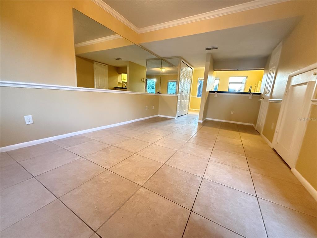 209 South Moss Road, Unit 209 Winter Springs, FL 32708 - Photo 4 of 14 a view of a kitchen with an empty space and a window