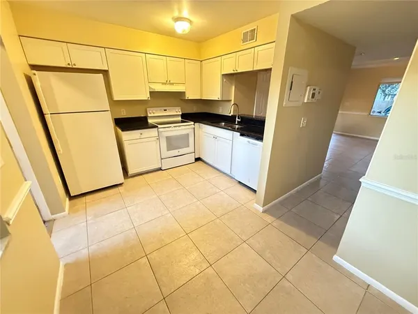 a kitchen with stainless steel appliances a refrigerator sink and cabinets