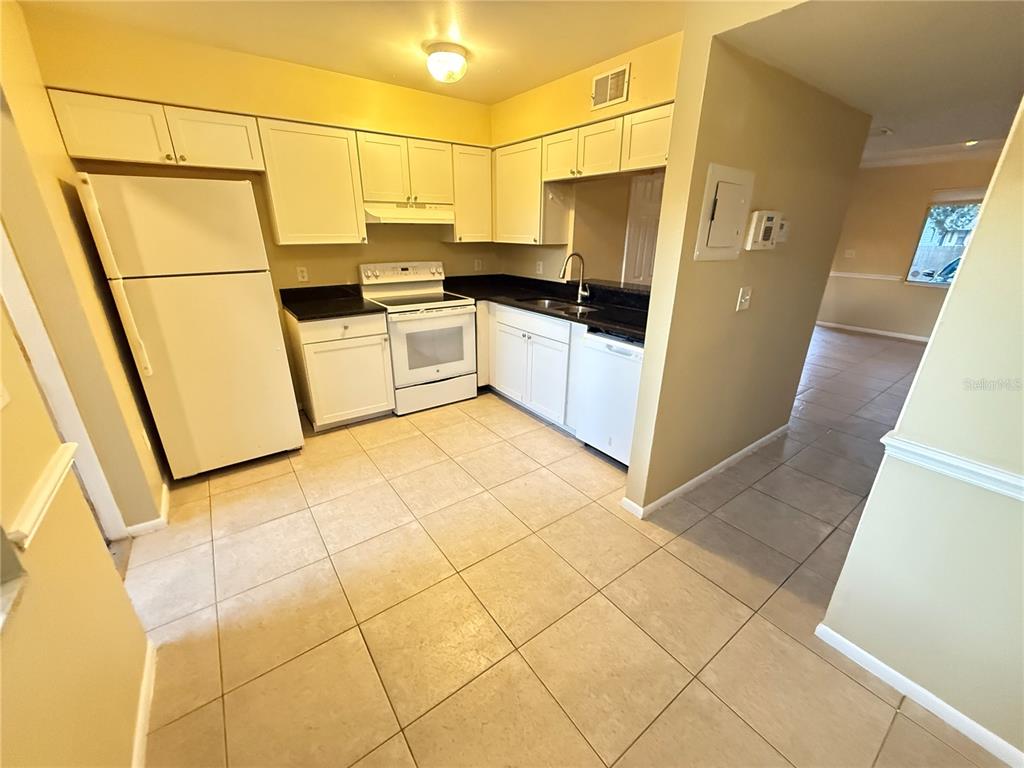 209 South Moss Road, Unit 209 Winter Springs, FL 32708 - Photo 7 of 14 a kitchen with stainless steel appliances a refrigerator sink and cabinets