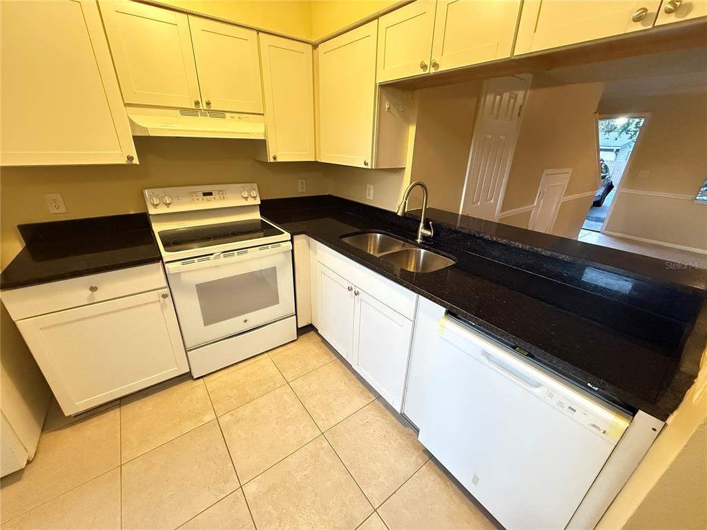 209 South Moss Road, Unit 209 Winter Springs, FL 32708 - Photo 8 of 14 a kitchen with a sink and a stove top oven