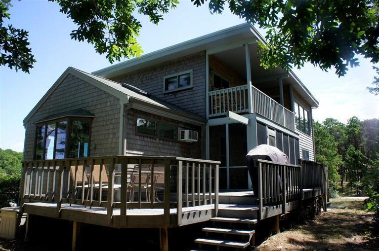 140 Fox Island Road Wellfleet, MA 02667 - Photo 1 of 23 a front view of a house with a garden