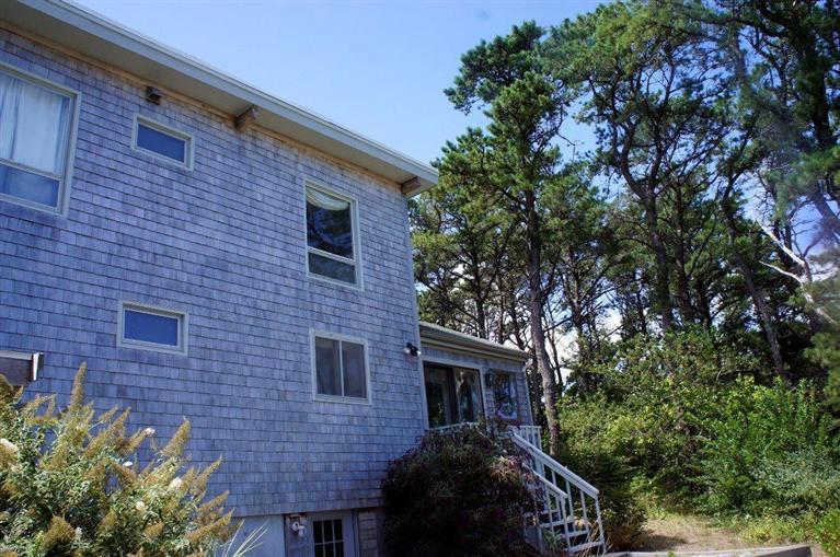 140 Fox Island Road Wellfleet, MA 02667 - Photo 19 of 23 a front view of a house with garden