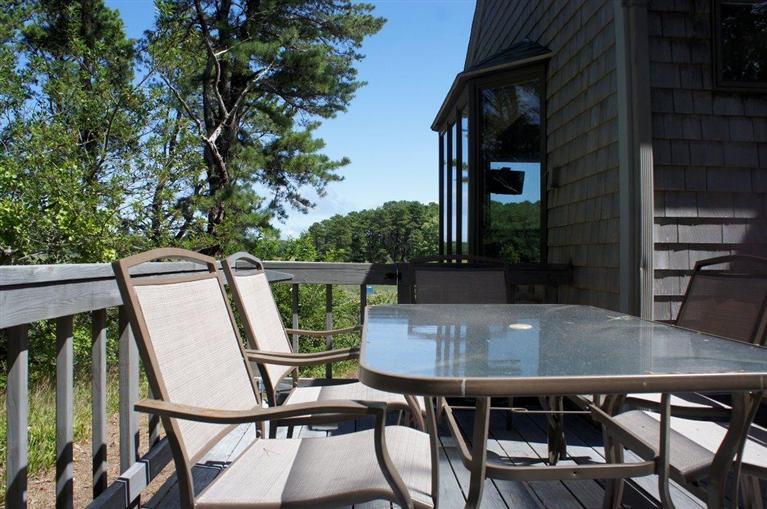 140 Fox Island Road Wellfleet, MA 02667 - Photo 2 of 23 a balcony with table and chairs