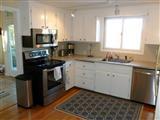 140 Fox Island Road Wellfleet, MA 02667 - Photo 9 of 23 a kitchen with a sink stove and microwave