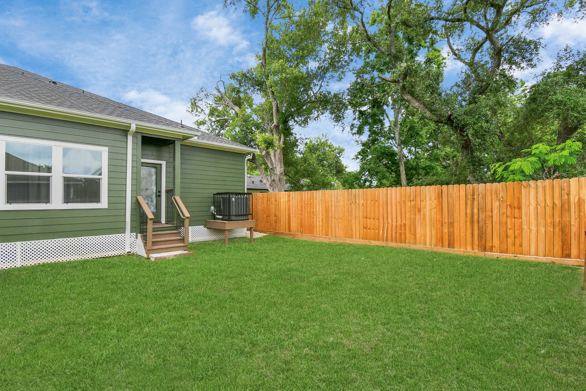 4909 Higgins Street, Unit A Houston, TX 77033 - Photo 31 of 32 a view of a backyard with wooden fence and a bench