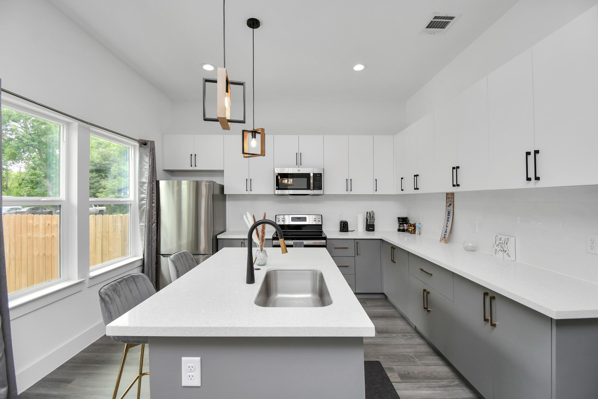 4909 Higgins Street, Unit A Houston, TX 77033 - Photo 4 of 32 a kitchen with a sink a stove and cabinets