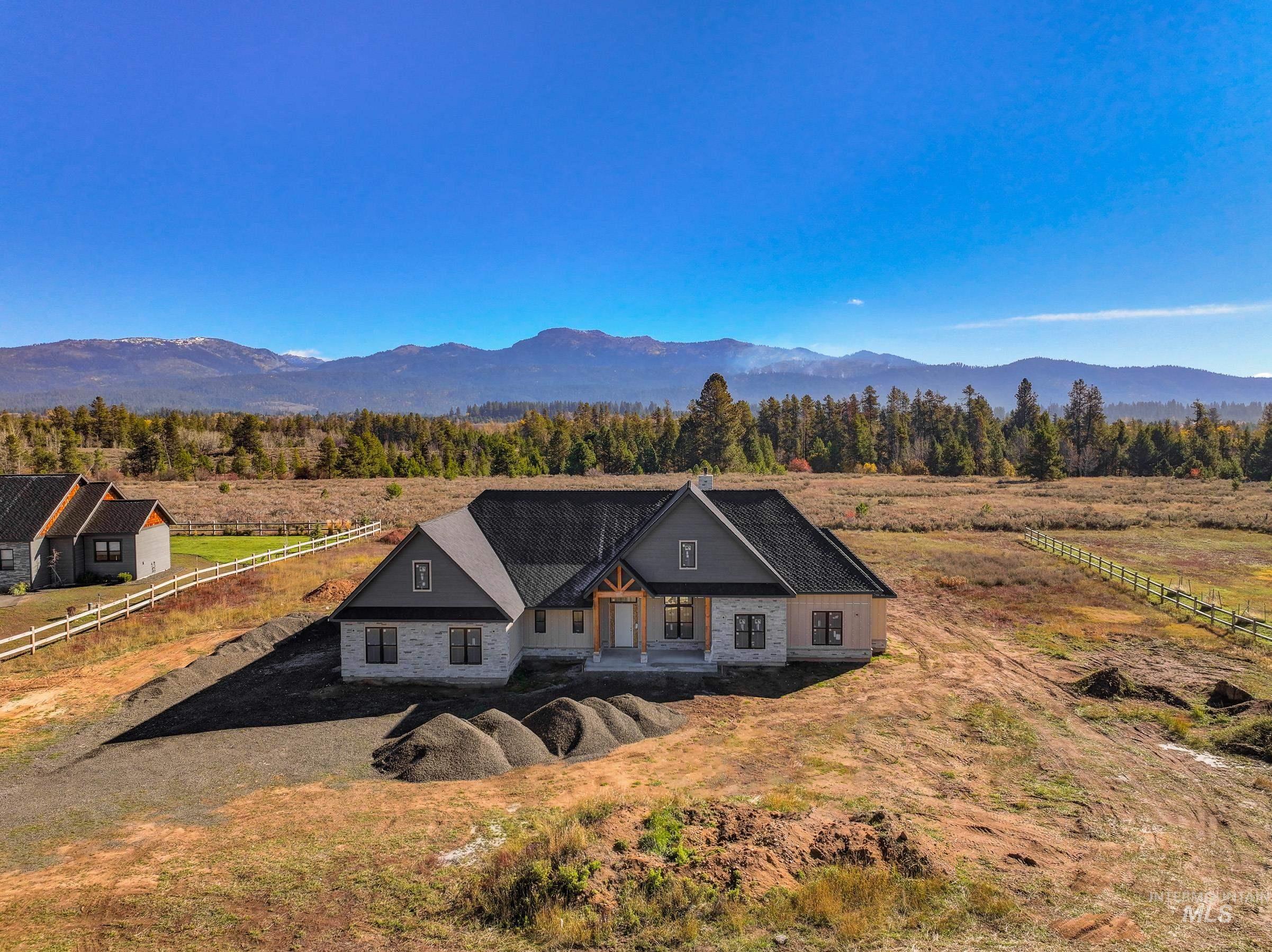 13910 Sky View Court, Unit 8 McCall, ID 83638 - Photo 18 of 40 View of front of house with a porch, a mountain view, and a view of countryside